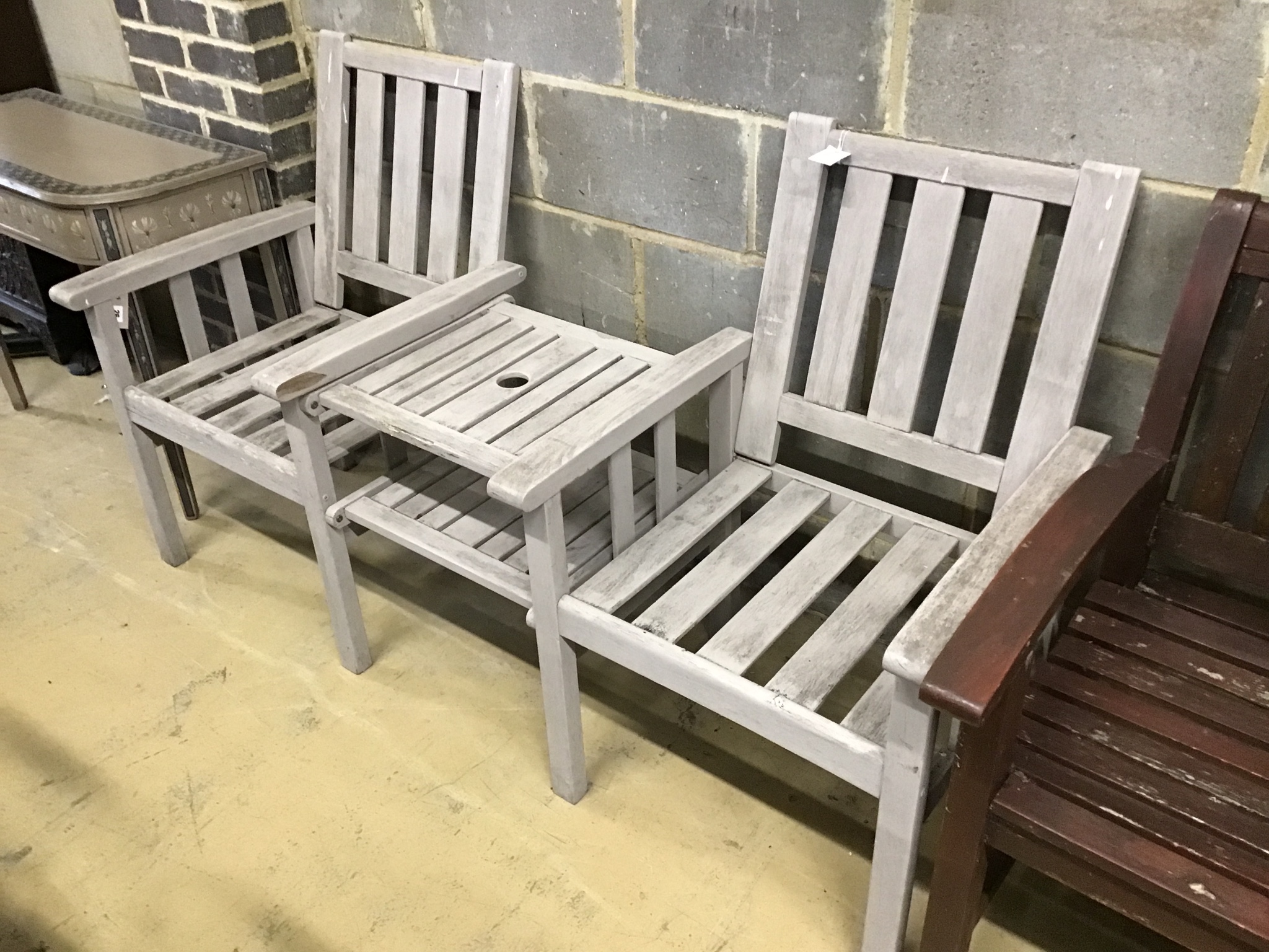 A weathered teak 'Jack and Jill' garden bench, width 168 cm, depth 65 cm, height 92 cm.